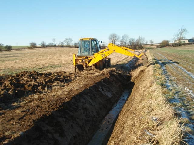 JCB 3CX digging a land-drainage ditch in the UK